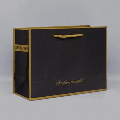 China Black Foil And Bump Logo Craft Paper Shopping Bag Reusable Twisted Handle 300g for sale