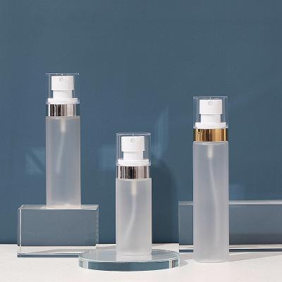 China Custom Logo 60ml 80ml 100ml White Frosted Fine Mist Spray Bottle Package PET Bottle With Gold And Silver Line Cosmetic Cap Package Container for sale