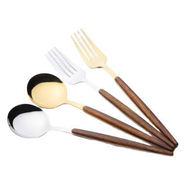 China Latest Design Stainless Steel Stocked Silverware With Wooden Handle Vintage Dinnerware Spoon Fork Set for sale