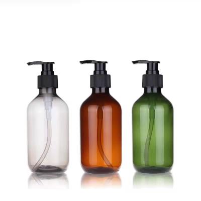 China Personal Care Boston Round Glass Bottles 500ml Amber Round Glass Boston Bottle with Stainless Steel Soap Pump Dispenser for sale