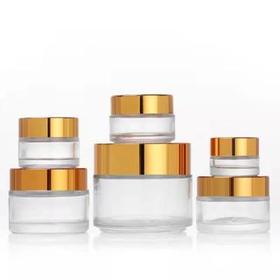 China Customized Cosmetic Face And Eye Cosmetic Cream Glass Bottle With Gold Cap for sale