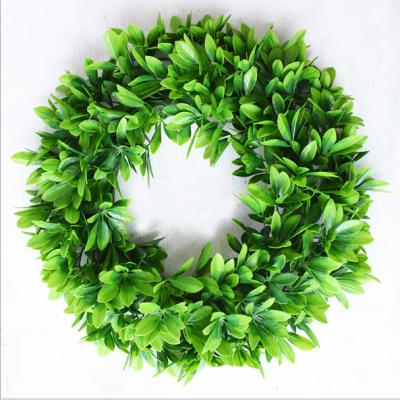 China Real Touch Nature Holiday Decor Artificial Green Leaves Wreath With Hanging Ribbon for sale