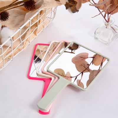 China Customized 2022 Newest Hot Selling Small MOQ Customized Cosmetic Pink Logo Square Shapes Mirror With Hand For Face for sale