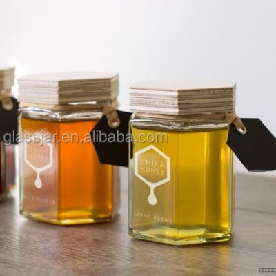 China 45ml small hexagon shape glass honey jar with wooden lid zu verkaufen