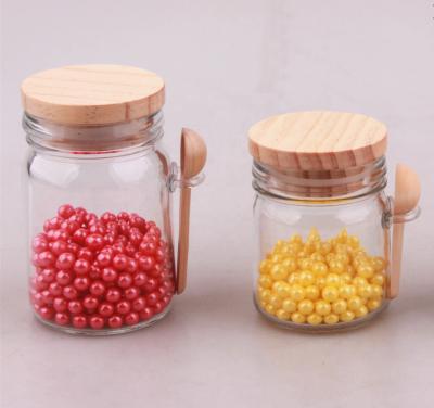 China Modern Bulk Candy 150ml Glass Jar With Wooden Lid And Wooden Spoon for sale