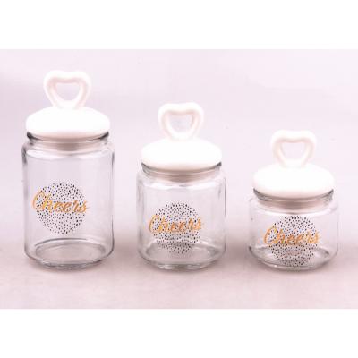 China Morden Luxury Glass Canister Jar With Heart Shape Ceramic Lid And Decal for sale