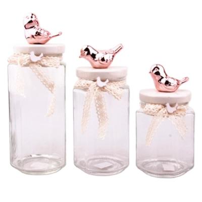 China 2018 modern new glass candy storage jar with bird rose gold lid for sale