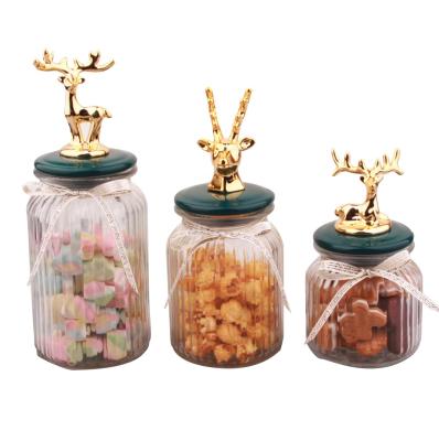 China Wholesale Glass Freshness Preservation Jar Storage Jar Container Candy Jar With Gold Ceramic Deer Lid for sale