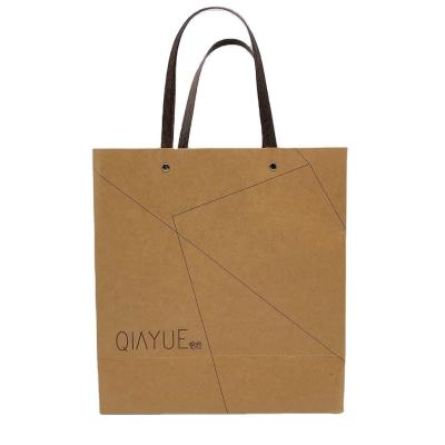 China Recyclable Professional Custom Kraft Paper Shopping Bags Security Portable Festival Gift Paper Packaging Bag for sale