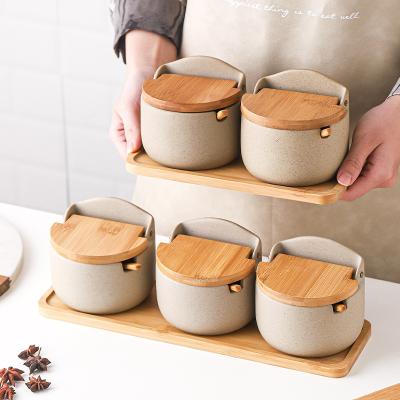 China Sustainable Luxury 3pcs Ceramic Kitchenware with Ceramic Spoon and Wooden Tray Spice Jar for sale