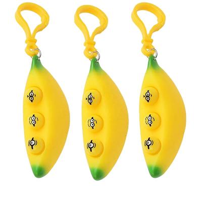 China New Design Squeeze Banana Key Chain Funny Eye Noise Wiggle Toy Pea Popper Banana Keychain Pendant Squeeze Toy for sale