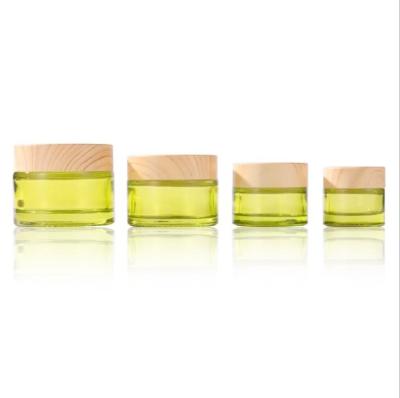 China Cheap price thick olive green cosmetic glass jar 20g 30g 50g recyclable with black cap for sale