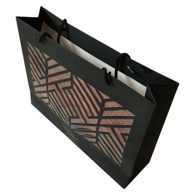 China OEM&ODM Recyclable Wholesale Custom Printed Black Luxury Paper Gift Shopping Bag With Handle for sale