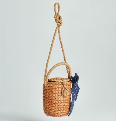 China Eco-friendly Handmade INS Woven Bucket Straw Basket With Bow for sale