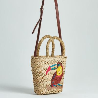 China 100% eco-friendly handmade kids cartoon straw bags with parrot embroidery with leather for sale