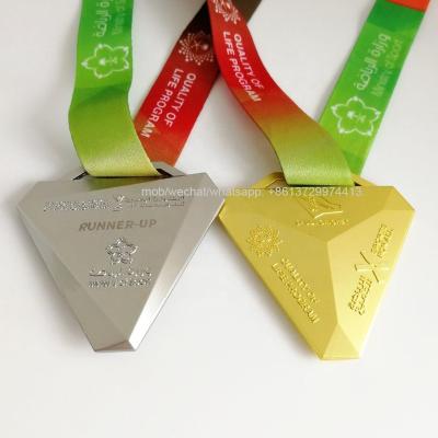 China World triangle shaped metallic matte gold and matte silver Saudi cricket medals with ribbon straps for sale