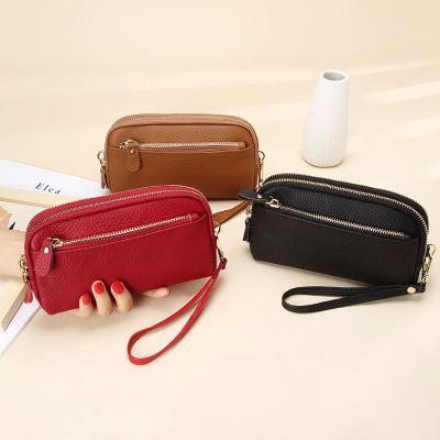 China 2022 remote control wholesale new style first pose cowhide ladies grab bag large capacity zipper mobile phone bag women wallet for sale