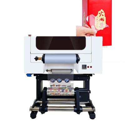 China Impresora DTF UV de 30 cm de rodillo a rodillo Impresora DTF UV A3 con laminador para pegatinas en venta