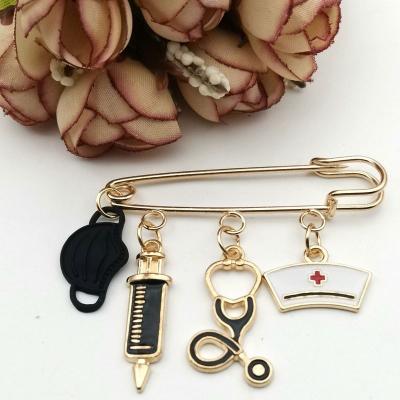 China Creative Medical Crystal Fashion Alloy Brooch Pin Syringe Stethoscope Brooch For Accessories for sale