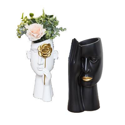 China Cute white and black potted flower porcelain human face home decor Nordic style cute white and black ceramic vases for sale