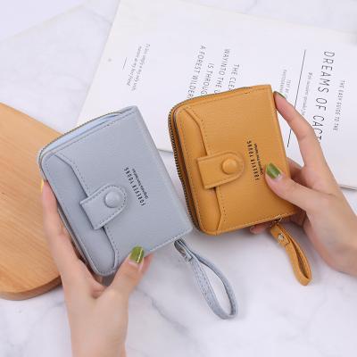 China RFID WAKED Custom PU Bifold Buckle Card Slots Short Organ Women Wallet for sale