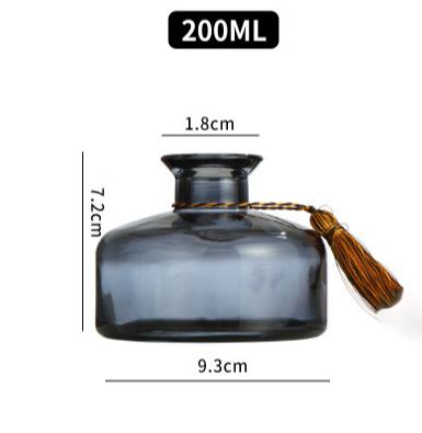 China Hot Empty Personal Care Rotated Glass Tubular Black Glass Aromatherapy Diffuser Perfume Bottle With Cap for sale