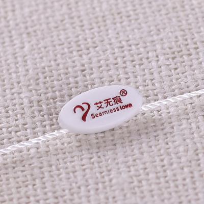 China Grain Word Hanging Custom Engraved Apparel Sustainable Garment Insert Double Bronzing Grain Custom LOGO Hanging Plastic Cocking Rope for sale