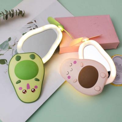 China 2020 New LED Lighted Avocado Mini Portable Makeup Mirror Fan With Makeup Mirror for sale