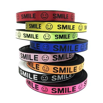 China High tenacity colorful 25mm nylon webbing 25mm high quality nylon webbing decorative high tenacity jacquard smile pattern woven belt webbing for sale