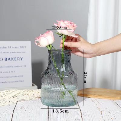 China Contemporary Bulk Mini Flower Vases Clear Decorative Embossed Style Glass Bottle Vases For Home Decor Wedding Centerpiece for sale