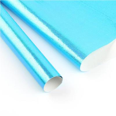 China Holographic Rainbow Gift Wrapping Waterproof Embossed Glossy Paper for sale