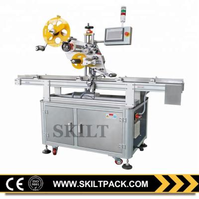 China Automatic CLOTHING Sticker Round Plastic Capsule Top Labeling Machine for sale