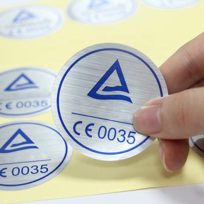 China Good Quality Strong Adhesive Waterproof Custom Printing Round Brushed Silver Foil Metallic Sticker for sale