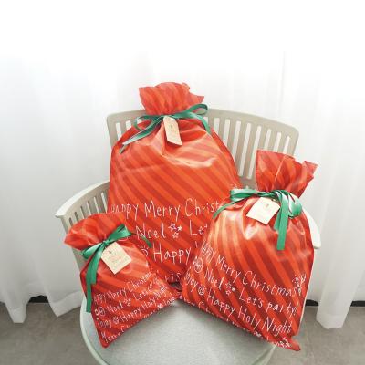 China Huadefeng Aseptic Christmas Drawstring Gift Bag Red Striped Nonwoven Drawstring Bag Custom for sale