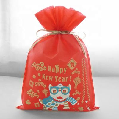 China Lion Pattern Drawstring Gift Packaging Disposable Pouches Bag Happy New Year Red Color PLA Nonwoven Material for sale