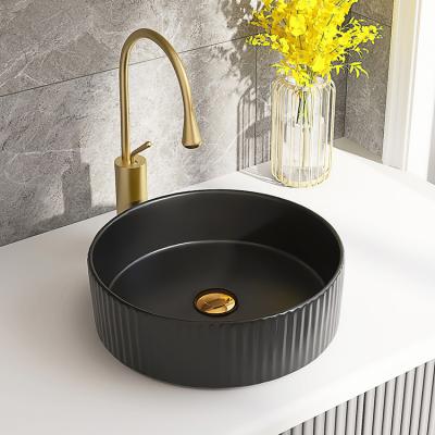 China Round Matte Black Modern Countertop Ceramic Lavatory Minimalist Fluted Vessel Sink Bathroom for sale