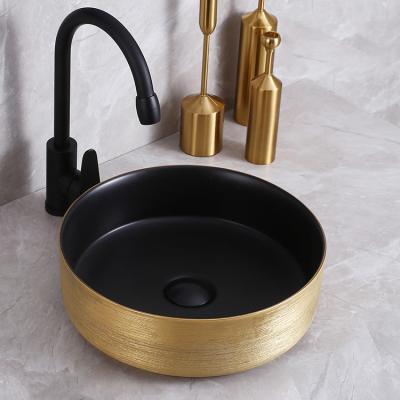 China Luxury Bathroom Sink Brushed Finish Mounted Gold And Matte Black Round Bathroom Sink Ceramic Wash Basin for sale