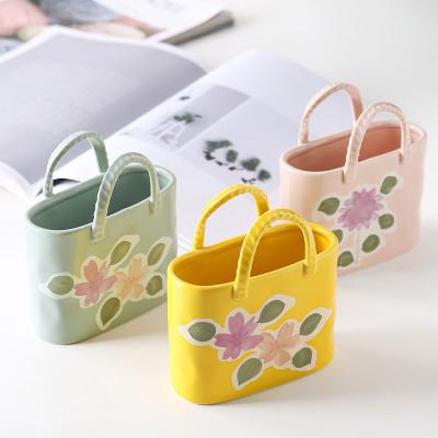 China New Contemporary Creative Design Cute Hand Painted Ceramic Pen Storage Container Modern Home Makeup Brush Flower Vase Handbag Table Decor for sale