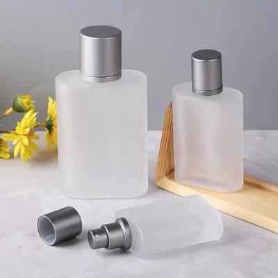 China Luxury Perfume 30ml 50ml Frosted Gold Pole Flattened Cap Silver Shape Mist Spray Glass Perfume Bottle With Packaging for sale