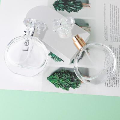 China Free Samples Luxury Clear Pole Flattened Shape Mist Spray Glass Perfume Bottle 25ml 50ml 100ml With Silver Foil Cap for sale