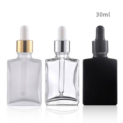 China Custom Cosmetic Sold White Essential Oil Cosmetic Packaging Square Transparent Black Frosted Glass Dropper Bottle With Rubber Cap for sale