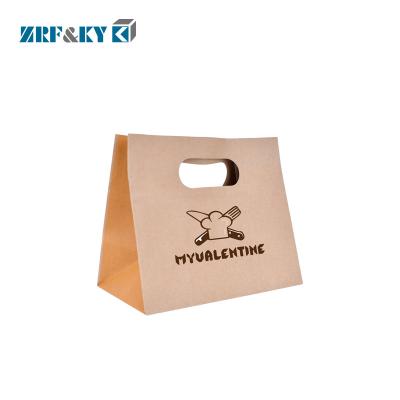 China Recyclable Custom Printed Brown Kraft Paper Shopping Bags with Hollow Handle for sale