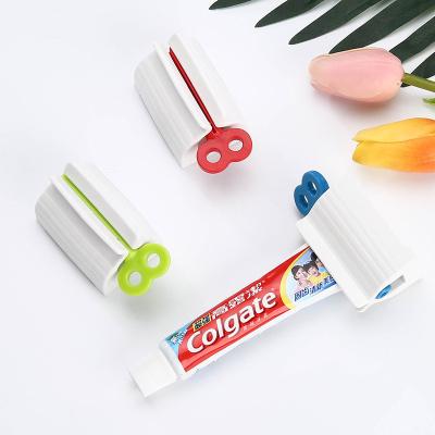 China Sustainable Tube Toothpaste Squeezer Toothpaste Seat Holder Custom Rolling Holder Rotate Dispenser For Bathroom for sale