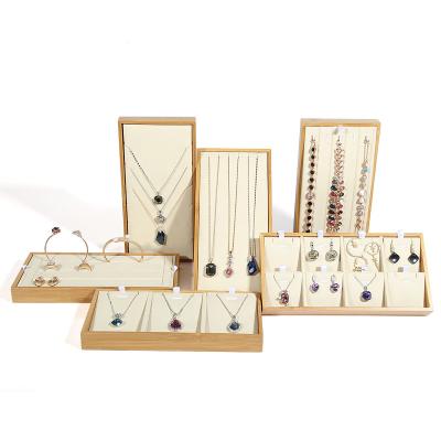 China Luxury Customized Wooden Complete Set Of White Leather Jewelry Display Tray For Ring Necklace Earring for sale