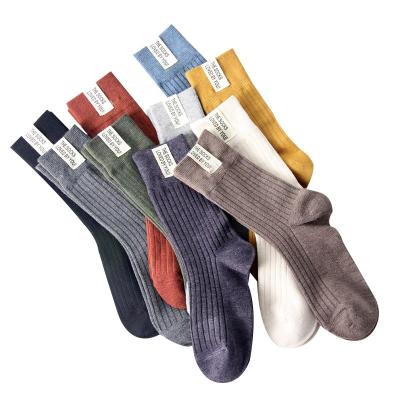 China Breathable socks new solid color cotton autumn and winter women's mid-tube stack pile unisex wholesale socks for sale