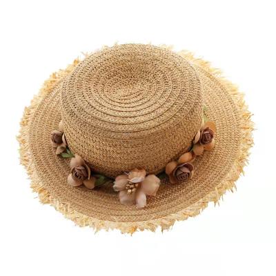 China Outdoor Fashion Child Straw Hat Lady Wide Brim Sun Protection Garland Flat Surface Beach Hat Folding Sun Hat for sale