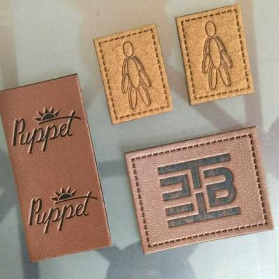 China Viable Accessory Manufacturer Sew On Leather Label Custom Design Debossed Logo Small PU Patches Leather Labels For Hat And Bag for sale