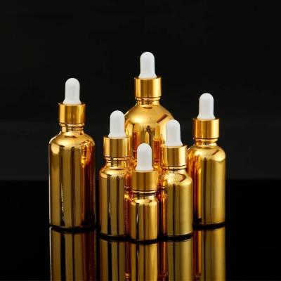 China Eco-friendly Recyclable Clad Glass Essential Oil Dropper Bottles 5ml 10ml 15ml 20ml 30ml 50ml Gold Dropper Bottle With Gold Child Safe Cap for sale