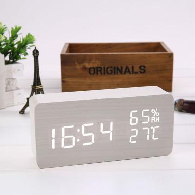 China Class Amazon Hot Selling LED Wooden Digital Alarm Clock with Wireless Phone Table Clock Charging Desk Clock for sale