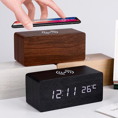 China Wooden Digital Calendars LED Alarm Clock with Wireless Phone Table Clock New Design Charging Desk Clock for sale